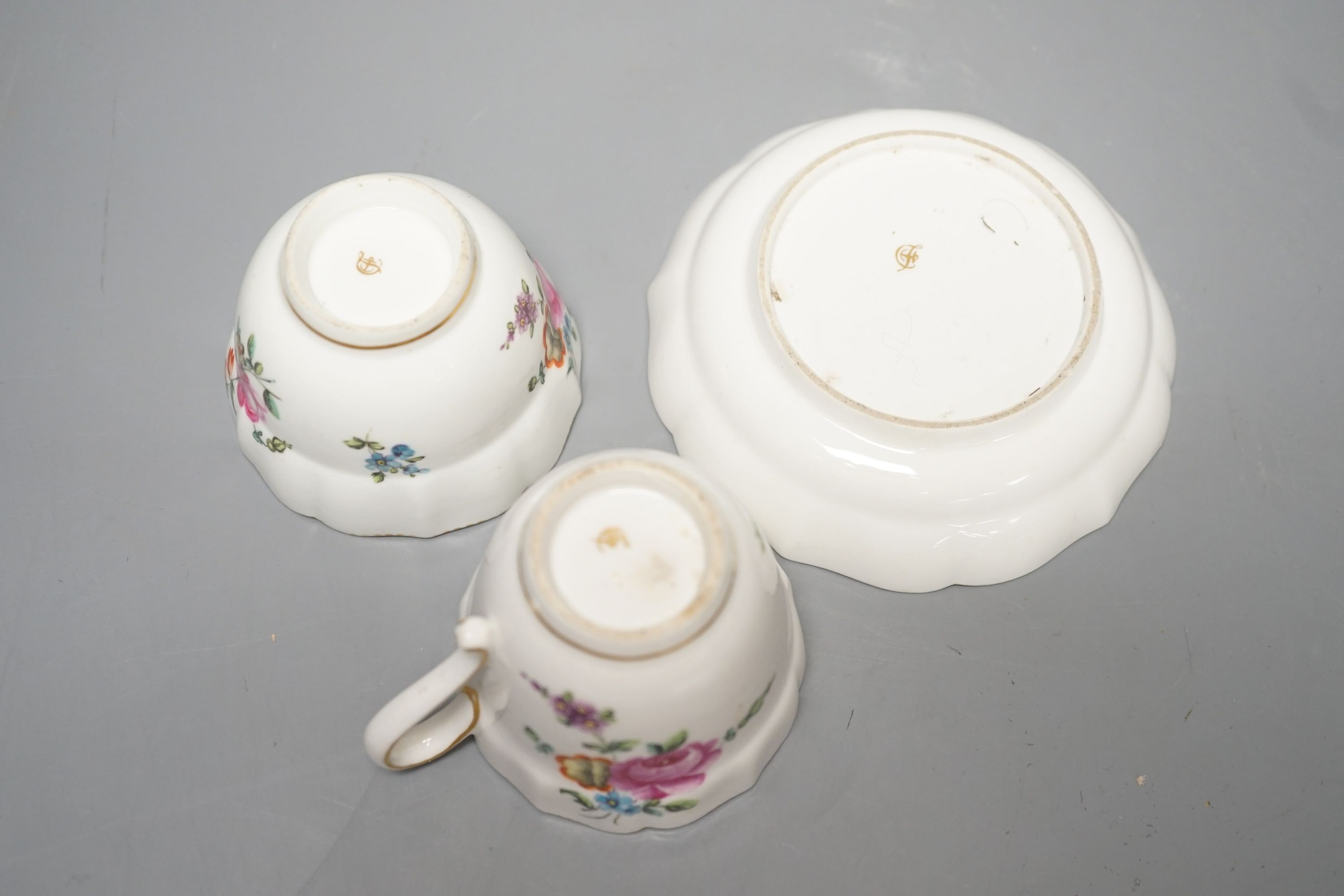 A Chelsea-Derby coffee cup, tea bowl and saucer painted with sprays and sprigs of flowers, c.1775, diameter 12cm